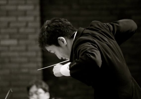 Conductor leading an orchestra