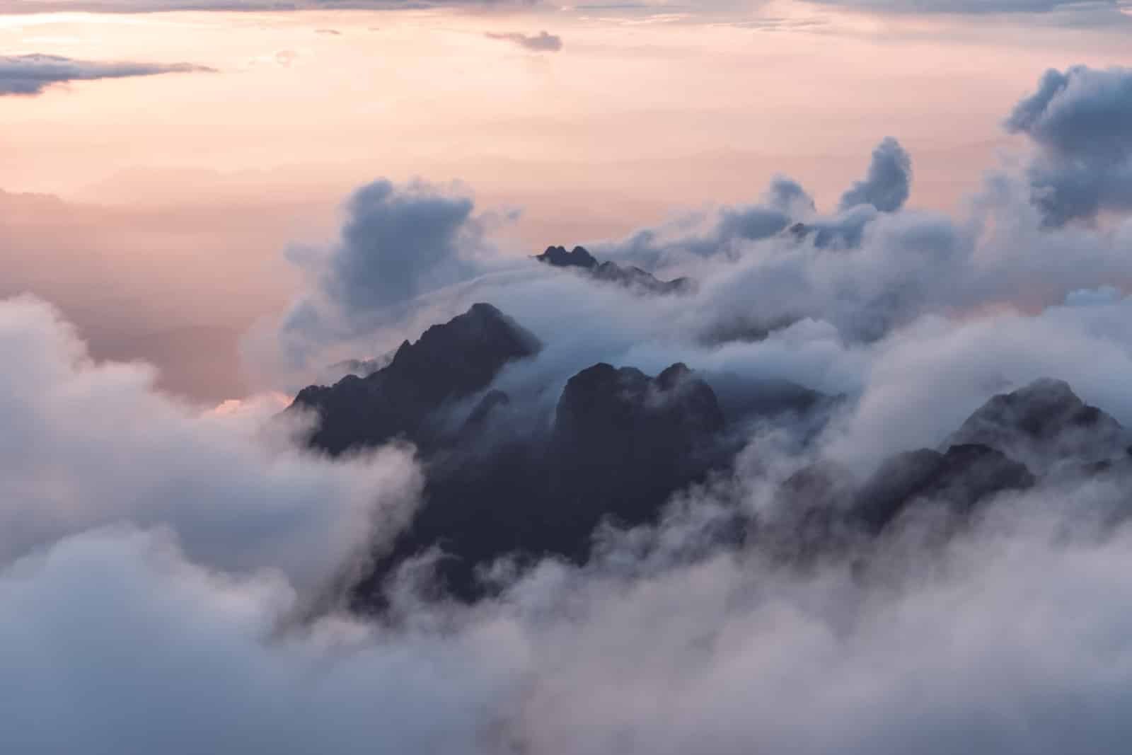 summit of a mountain through the clouds