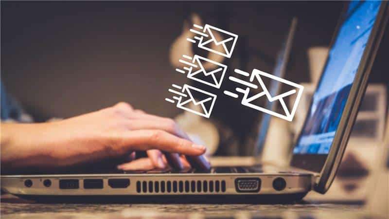 hands on a laptop keyboard sending an email